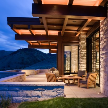 Exterior, horizontal, covered patio with cantilevered beams at twilight, Frey residence, Ketchum, Idaho; McLaughlin & Associates Architects