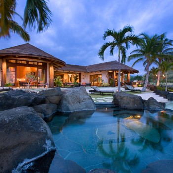 Exterior, horizontal, overall rear elevation and terrace with pool, hot tub and tiki torches at twilight, Sander residence, Manini'owali Kuki'o, Kailua-Kona, Hawaii; McLaughlin & Associates Architects; Studio Waterman