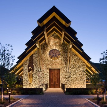 Exterior, square, front entry at twilight, Our Lady of the Snows Church, Ketchum, Idaho; McLaughlin & Associates